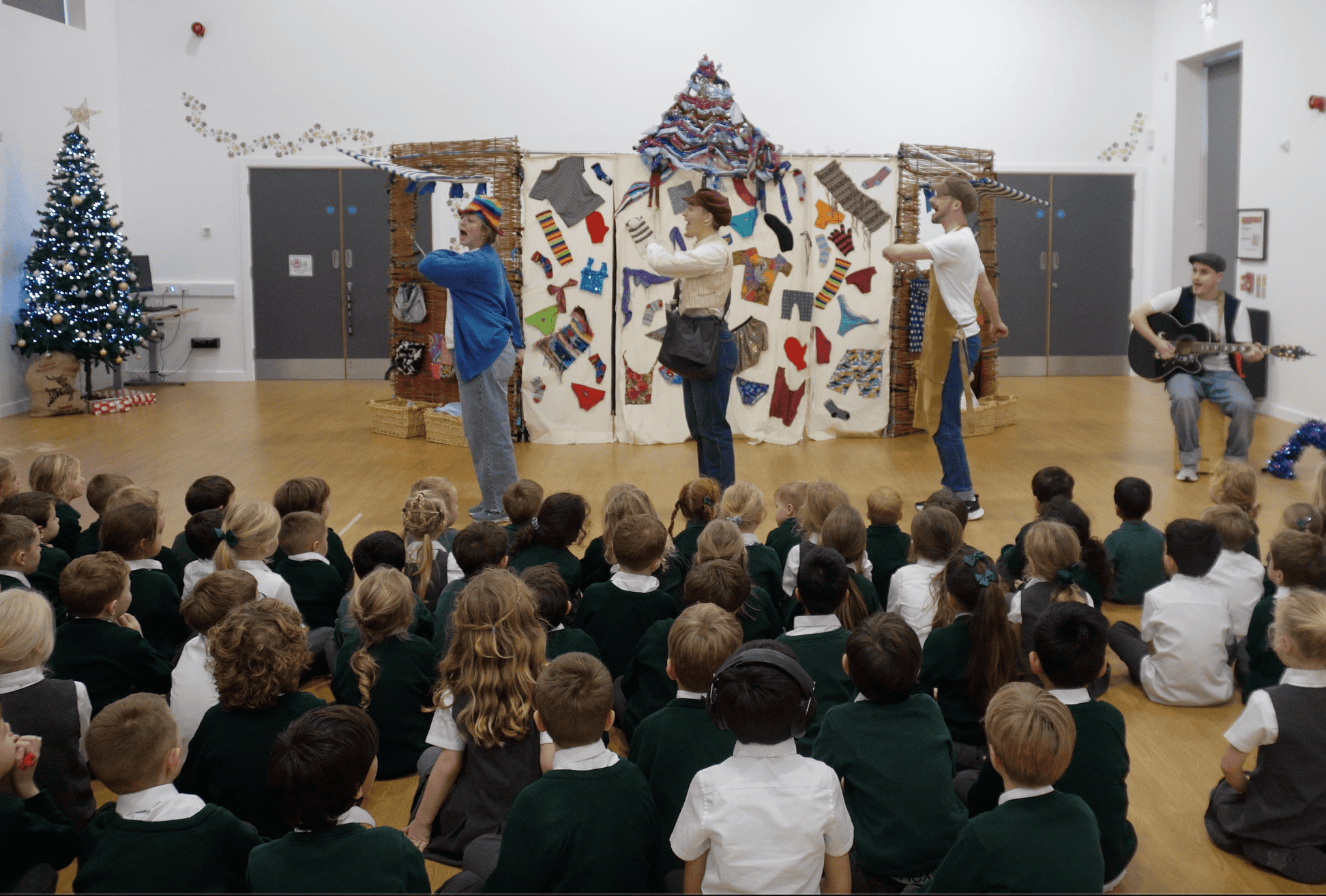 Performers from theatre acting on stage infront of pupils